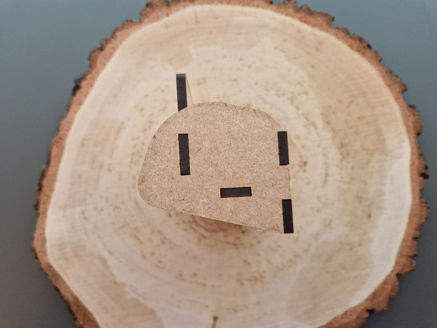 wooden business cardholder displayed on log slice