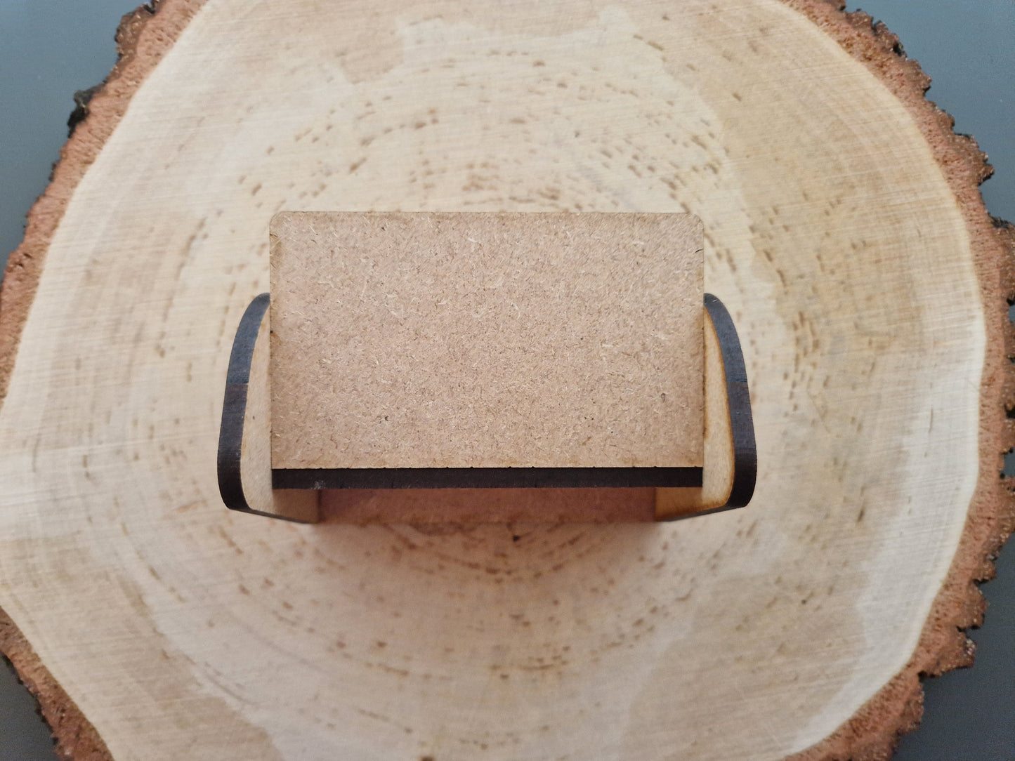 wooden business cardholder displayed on log slice