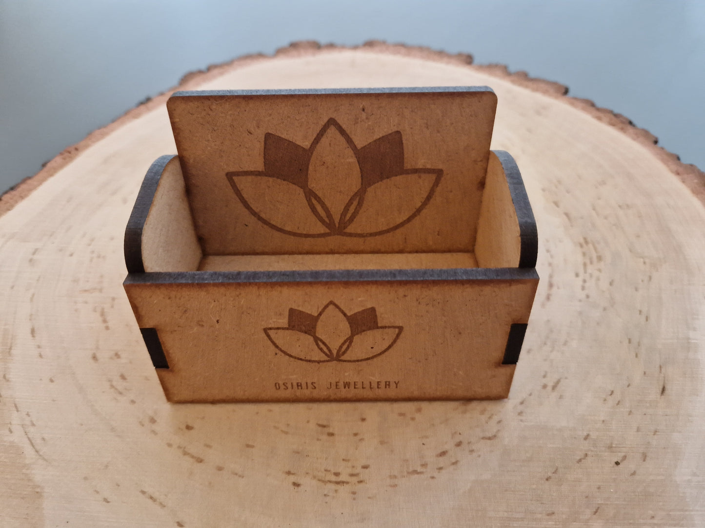 wooden business cardholder displayed on log slice