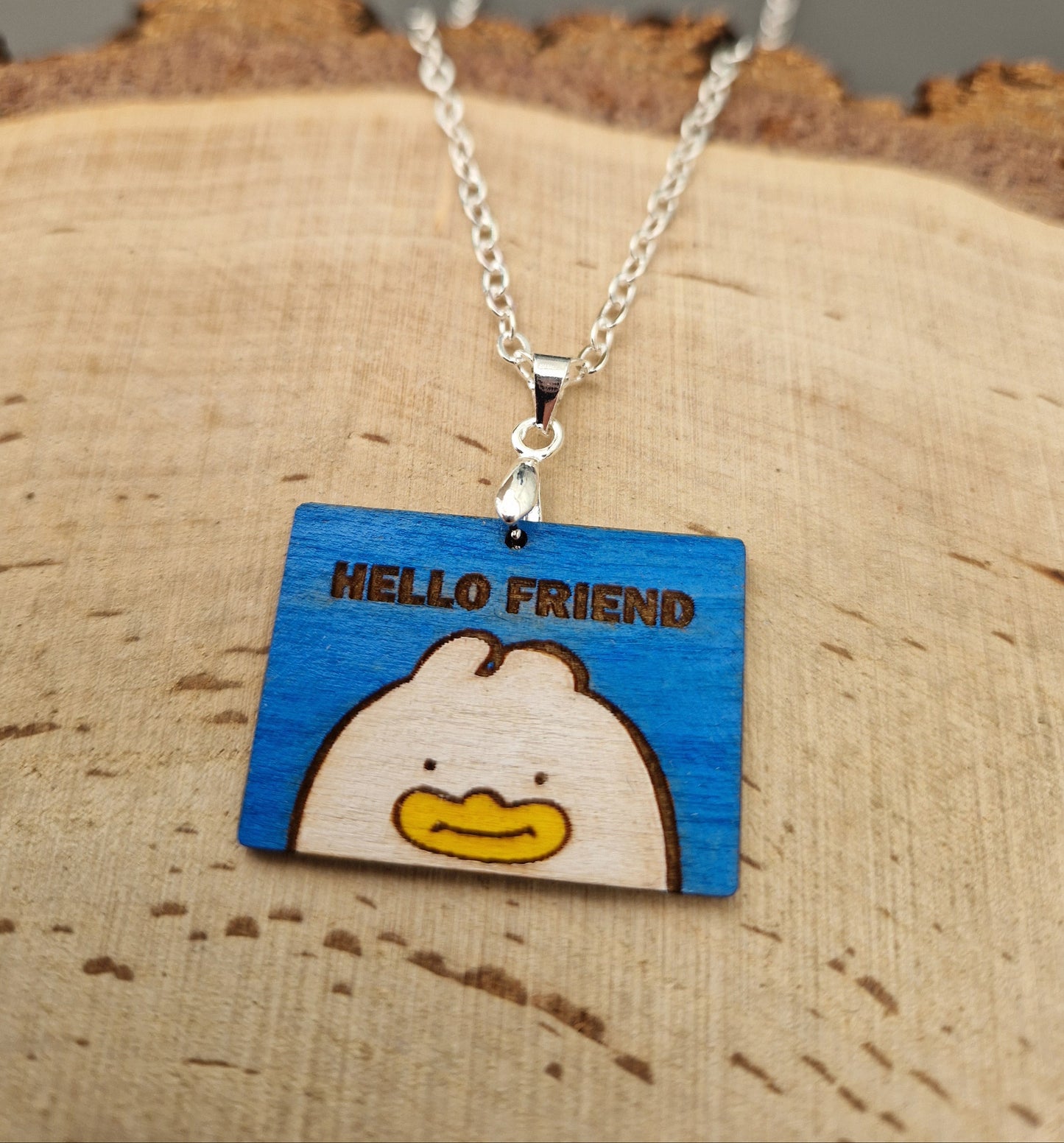 Necklace with a wooden pendant featuring the Hello friend not card from kpop demon hunters