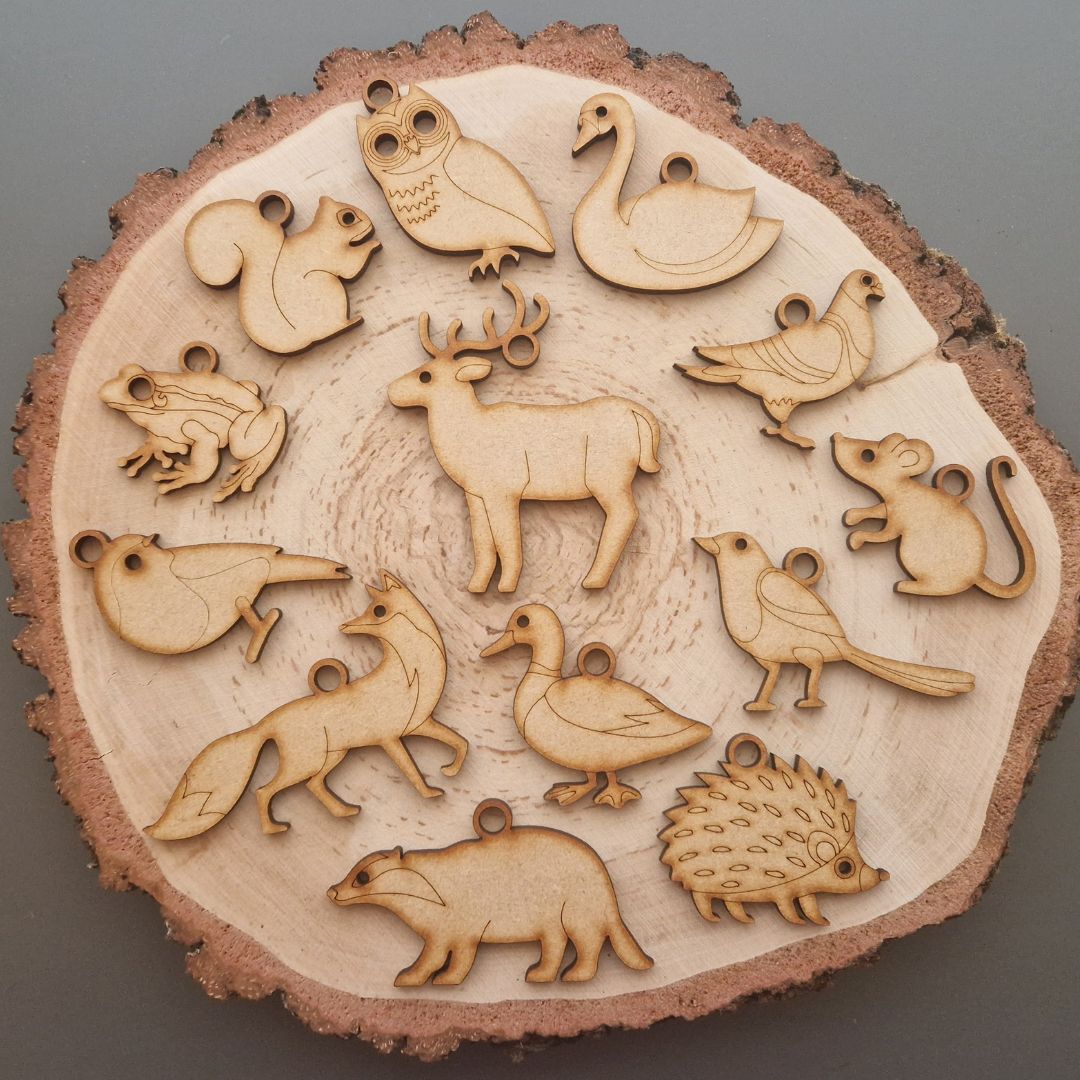 wooden woodland animal shapes on log slice