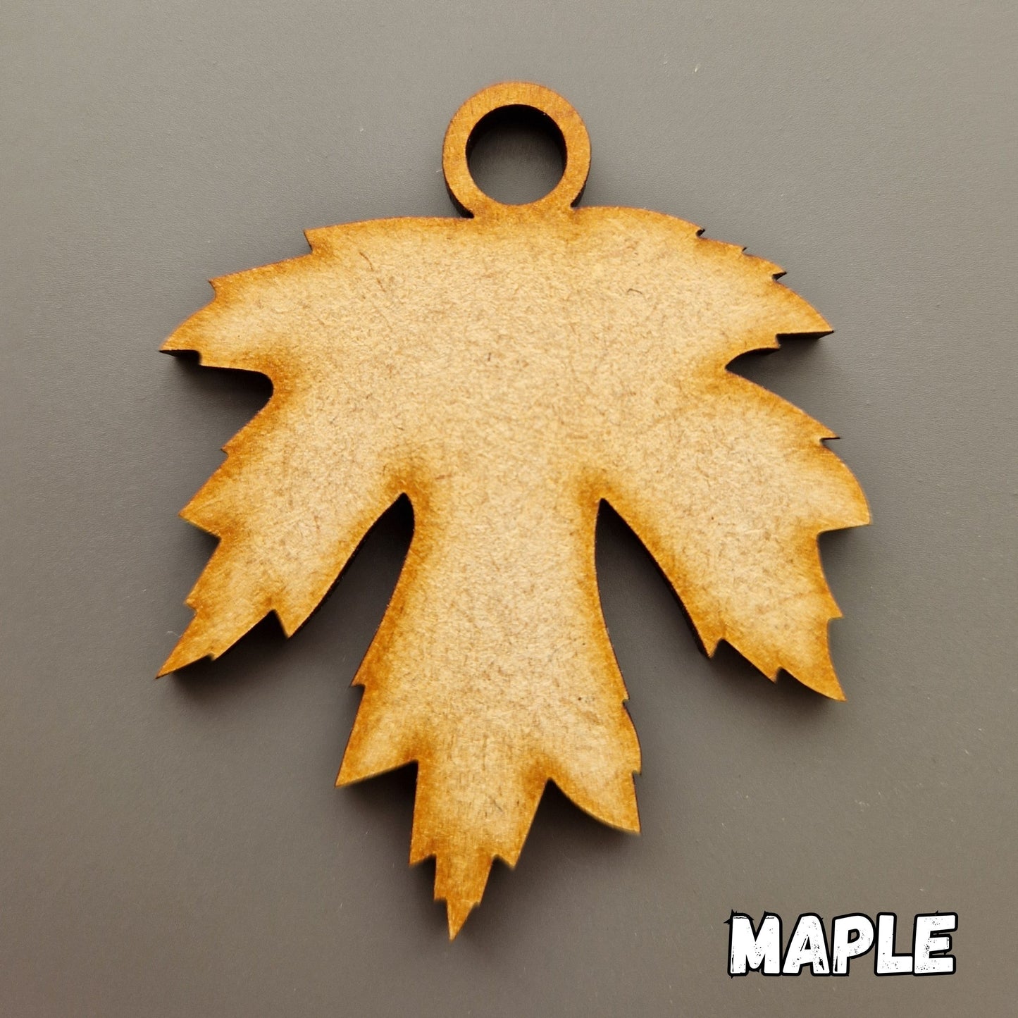 Wooden leaf shape displayed on grey background