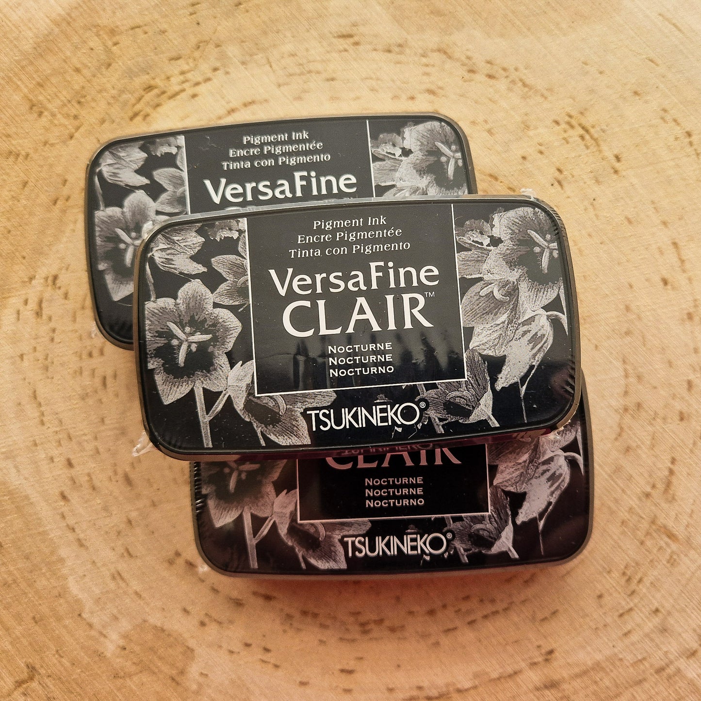 Versafine clair black ink pad displayed on wooden background