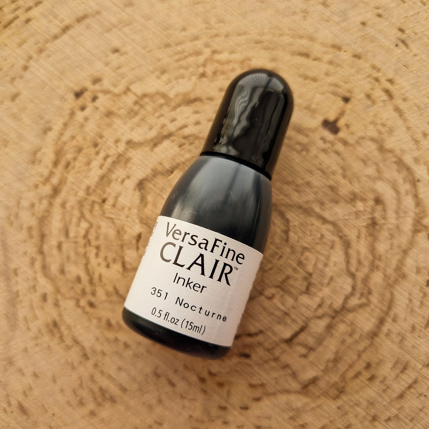 Versafine clair black inker displayed on wooden background