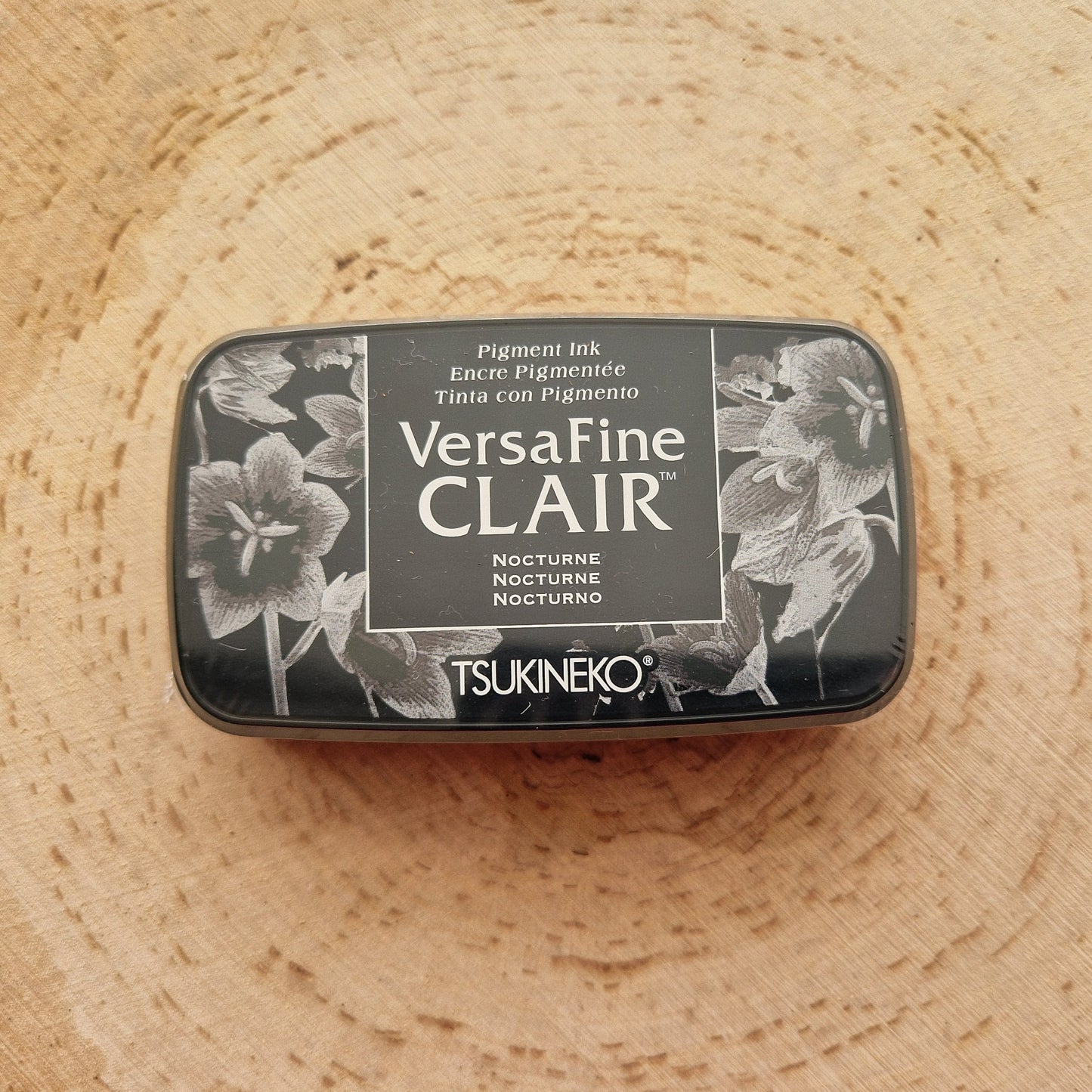 Versafine clair black ink pad displayed on wooden background