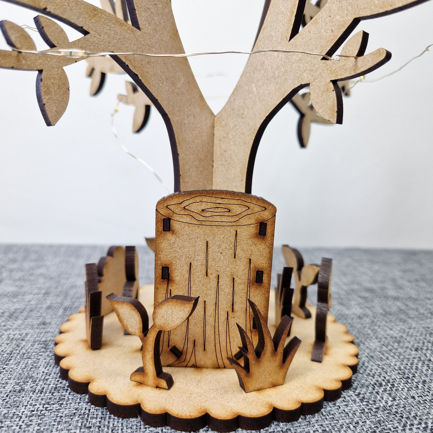 wooden tree with base displayed on grey background