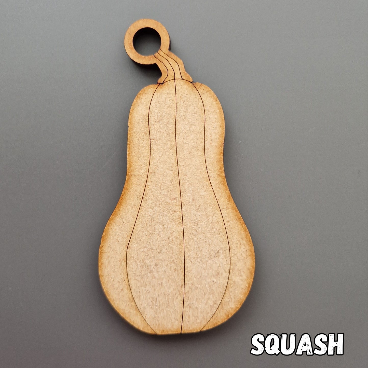 wooden butternut squash shape displayed on grey background