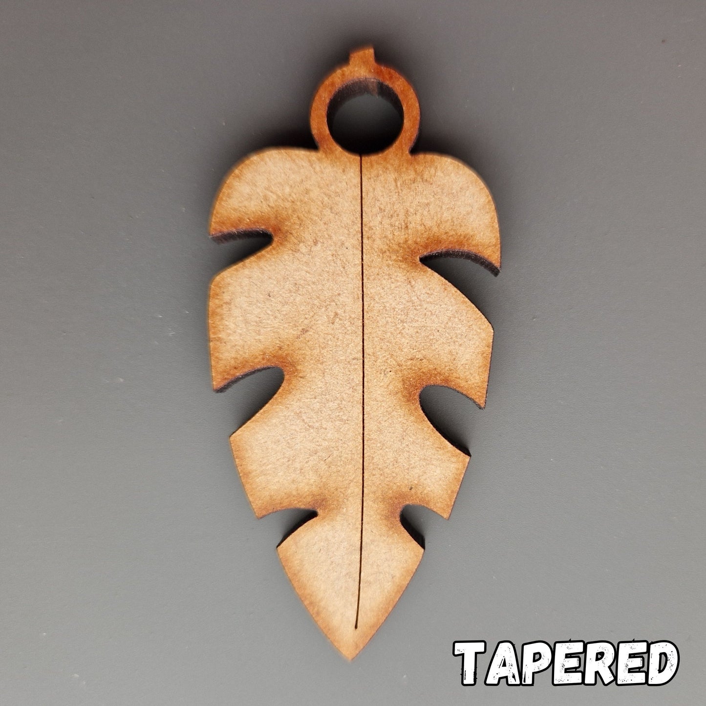 Wooden leaf shape displayed on grey background