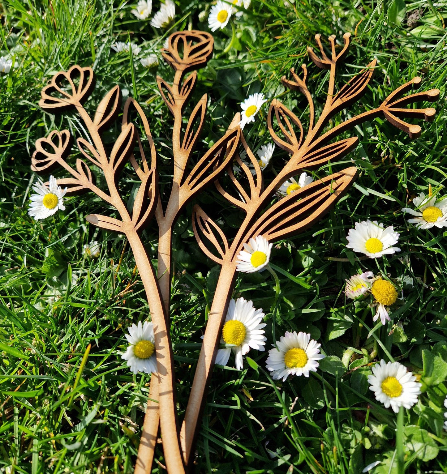 wooden flowers displayed on grass
