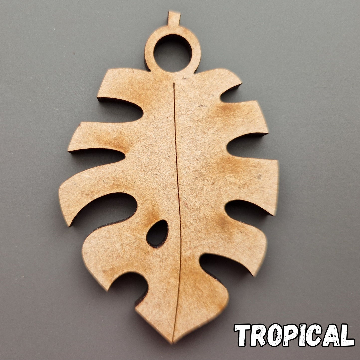 Wooden leaf shape displayed on grey background