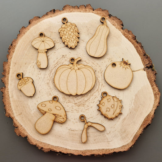 wooden autumn shapes displayed on log slice