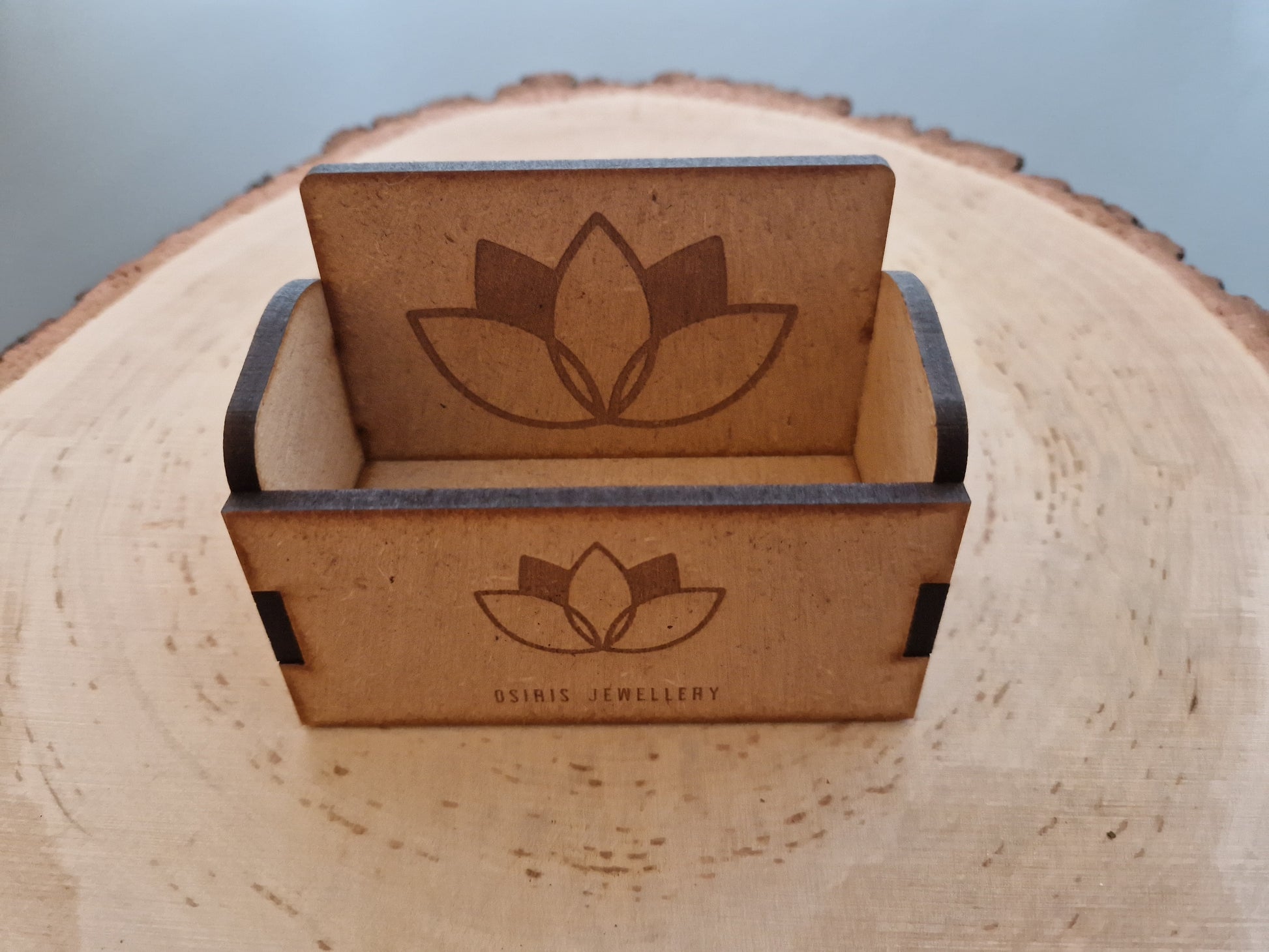 wooden business cardholder displayed on log slice