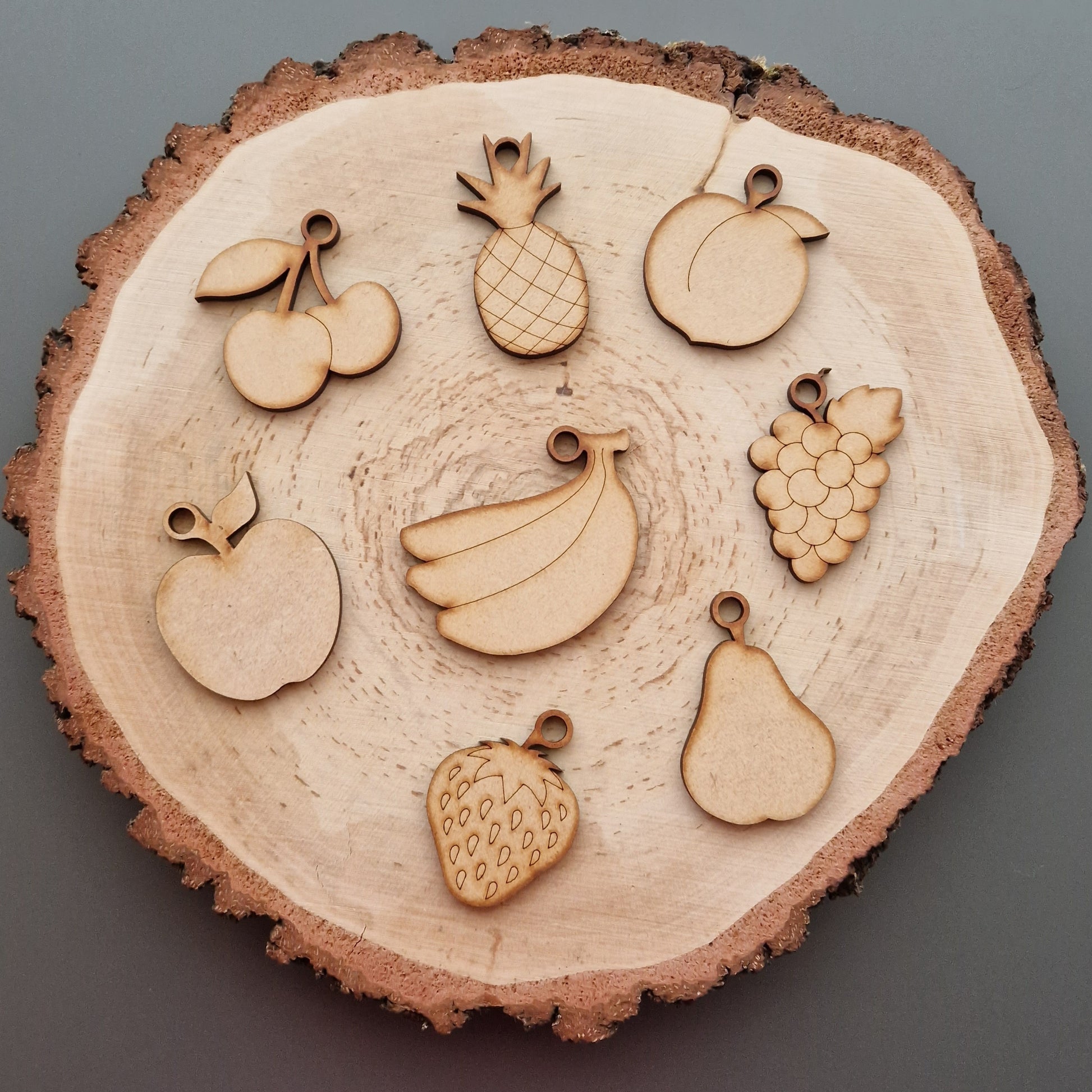 wooden fruit shapes displayed on log slice