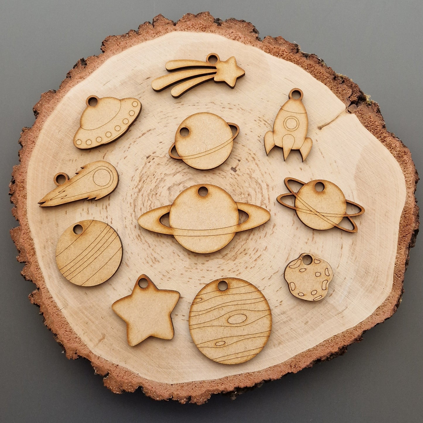 wooden space shapes on log slice