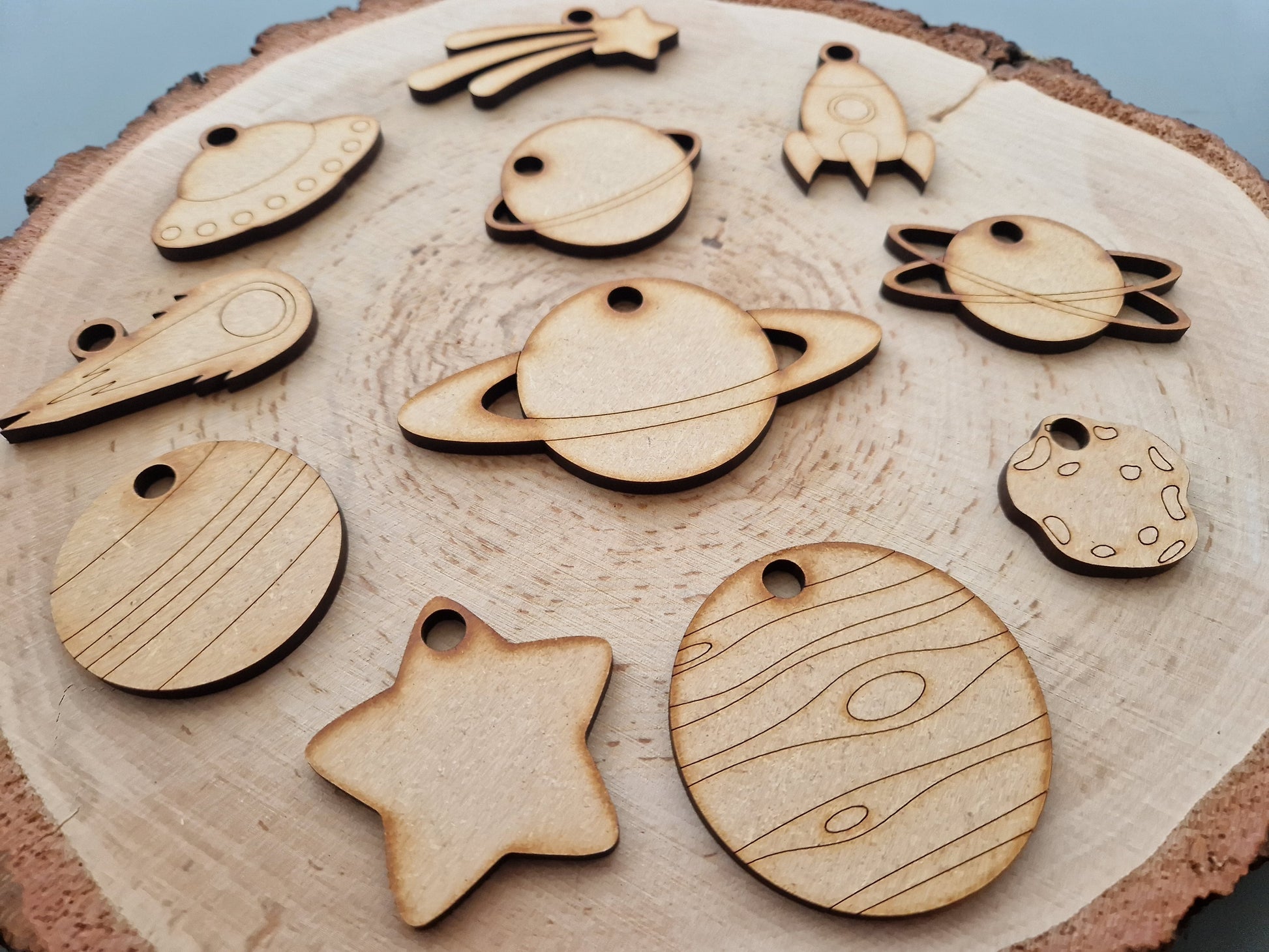 wooden space shapes on log slice