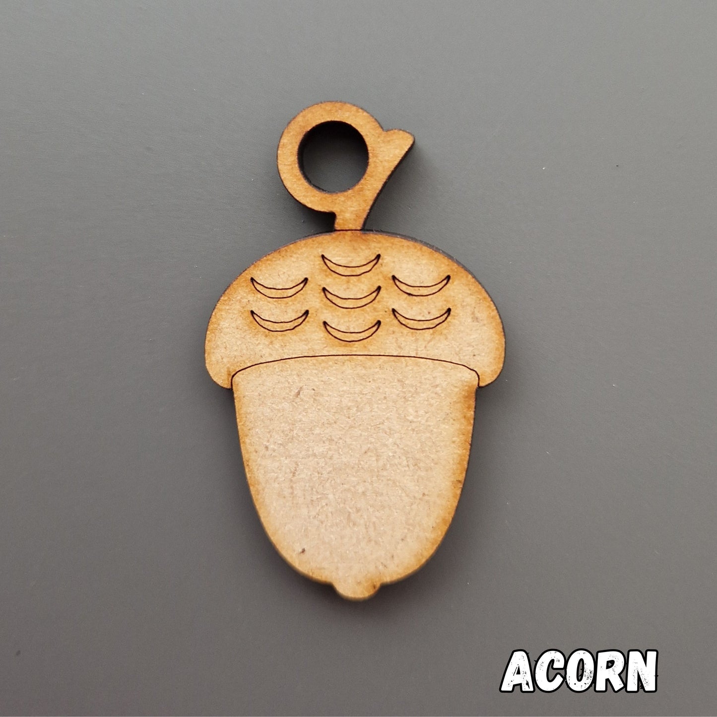 wooden acorn shape displayed on grey background