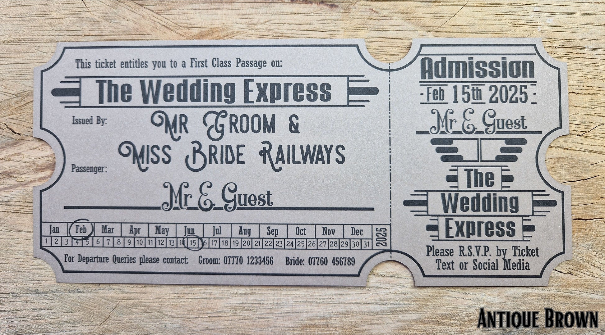 Vintage train ticket wedding invites displayed on a wooden background