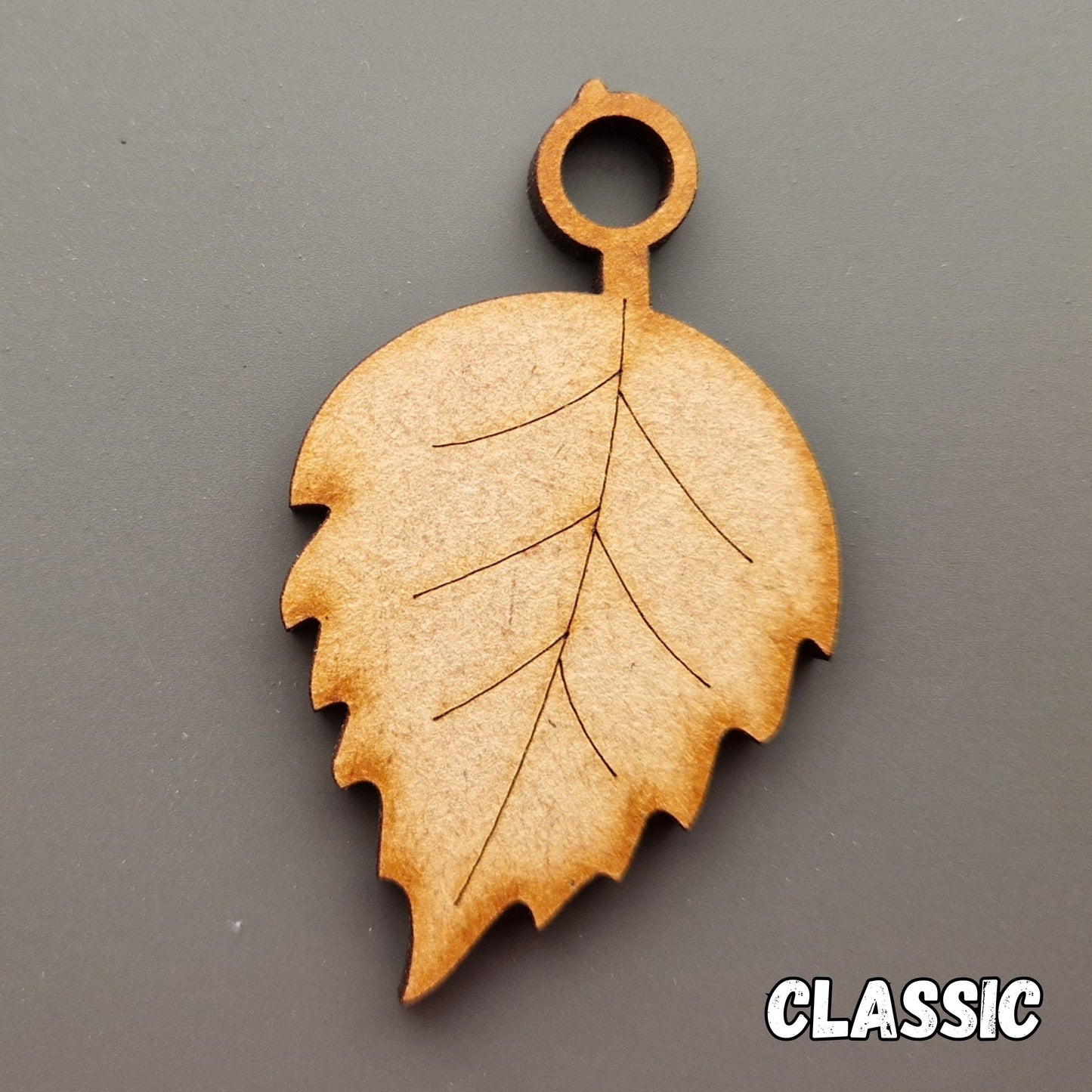 Wooden leaf shape displayed on grey background