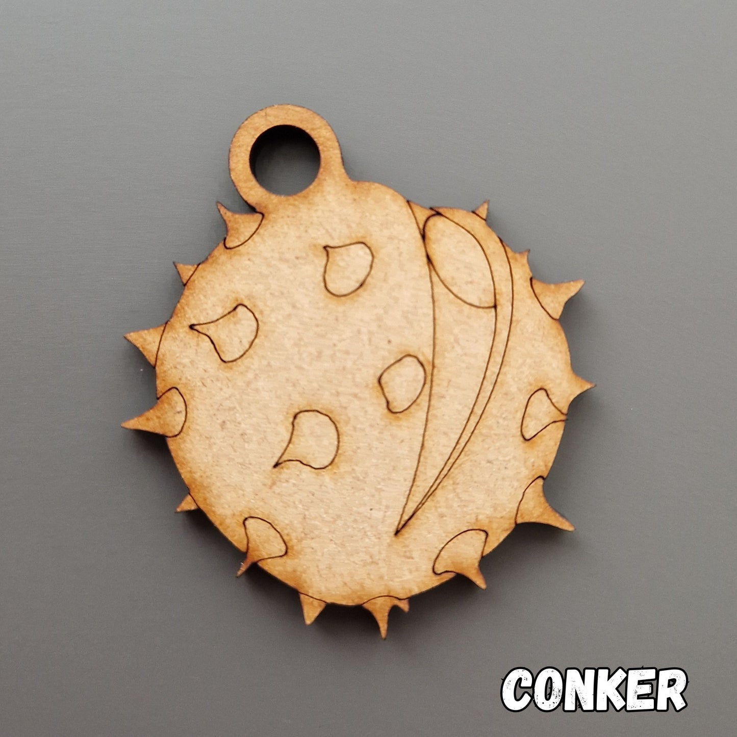 wooden conker shape displayed on grey background