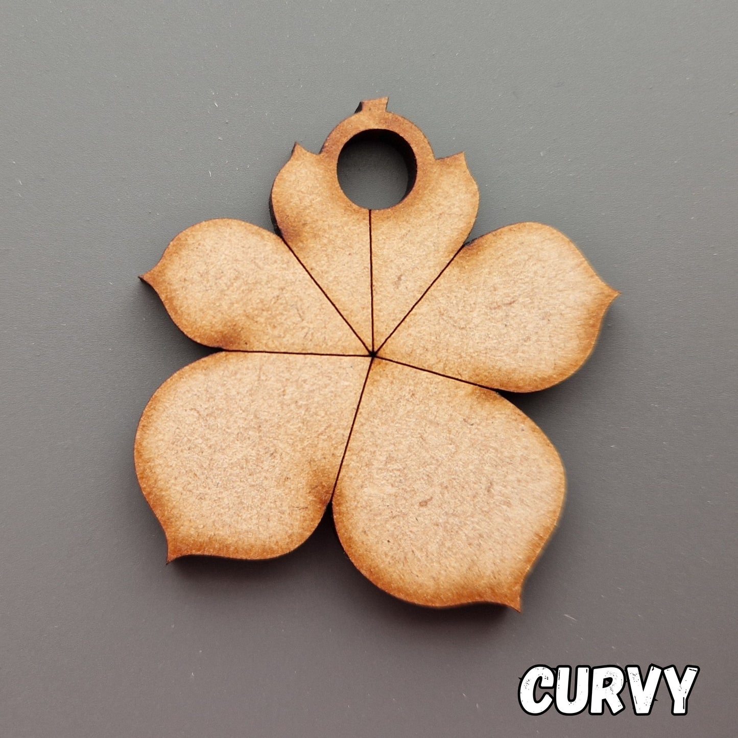 Wooden leaf shape displayed on grey background