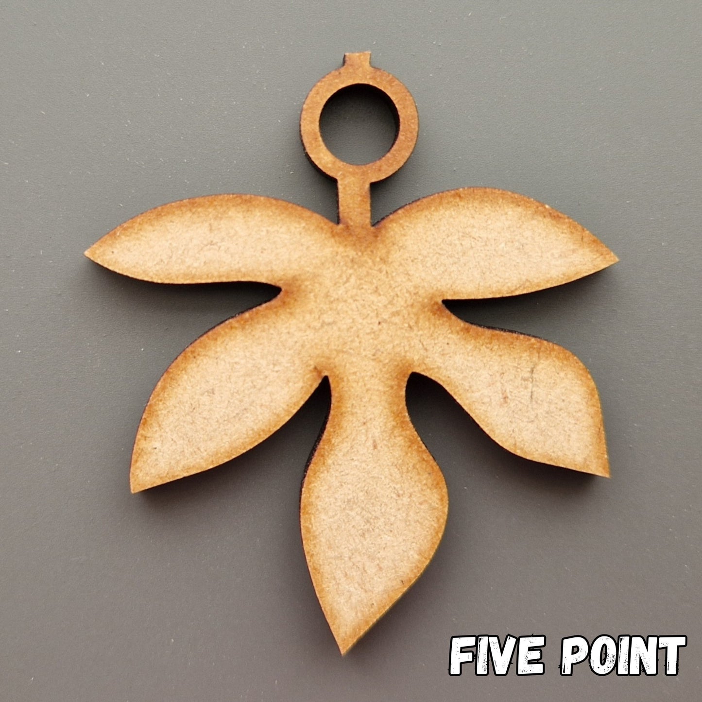 Wooden leaf shape displayed on grey background