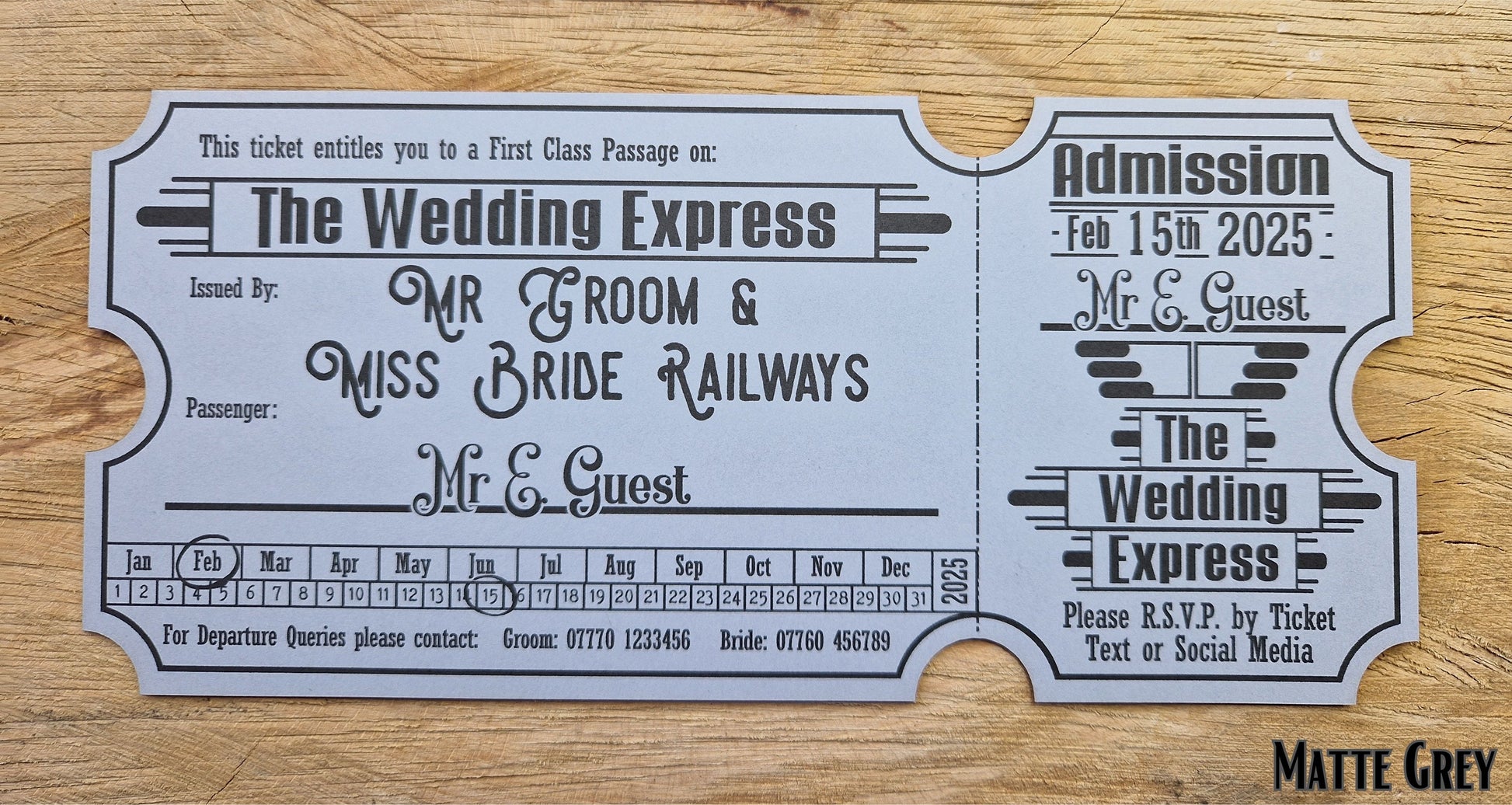 Vintage train ticket wedding invites displayed on a wooden background