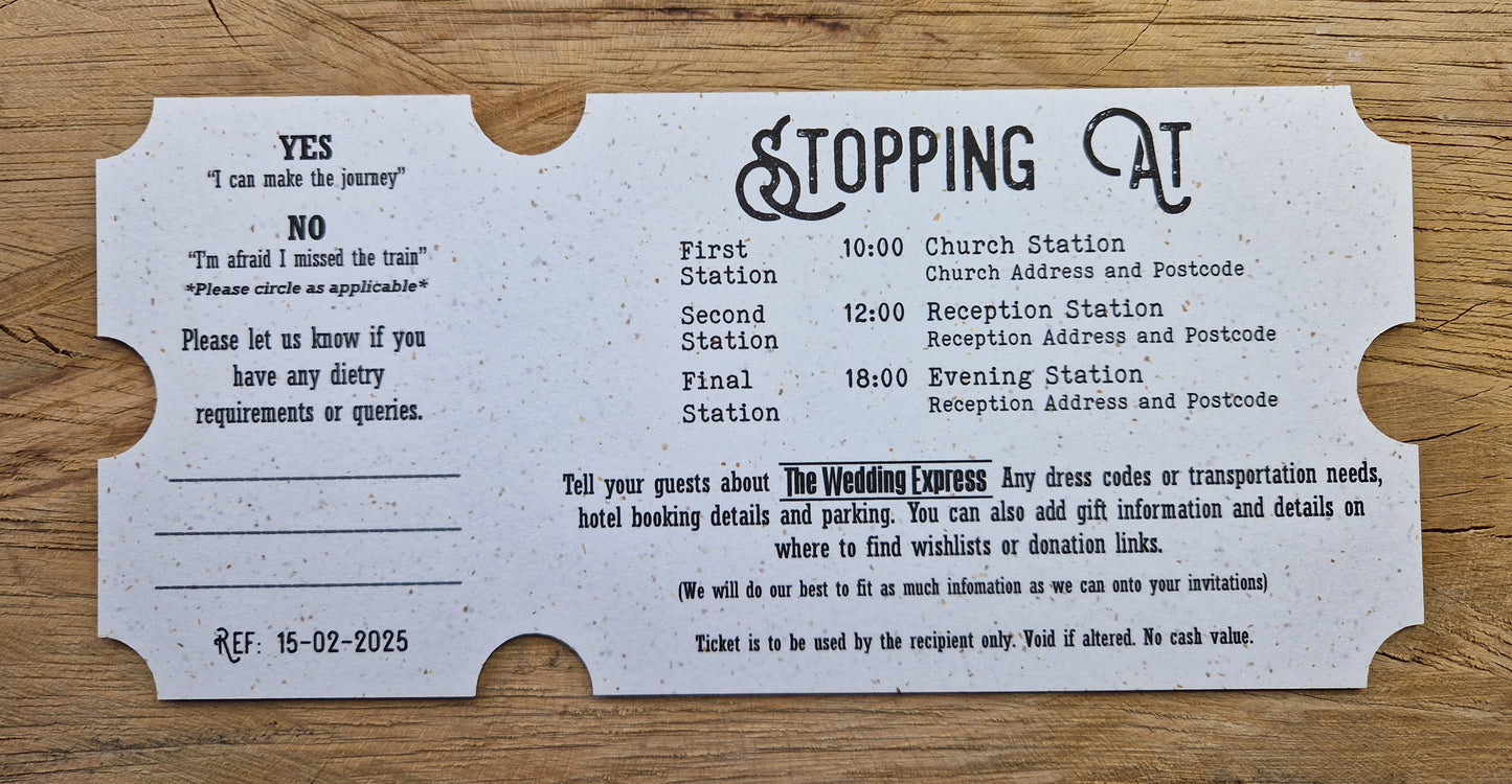 Vintage train ticket wedding invites displayed on a wooden background