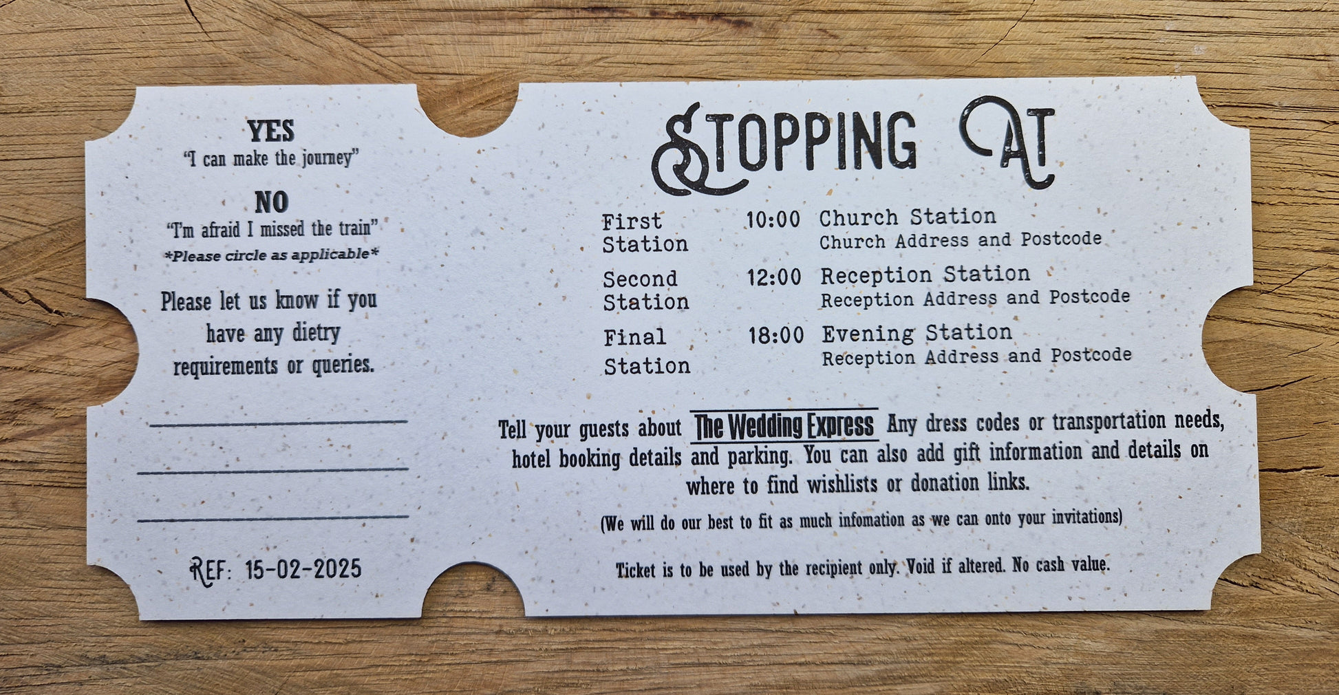 Vintage train ticket wedding invites displayed on a wooden background