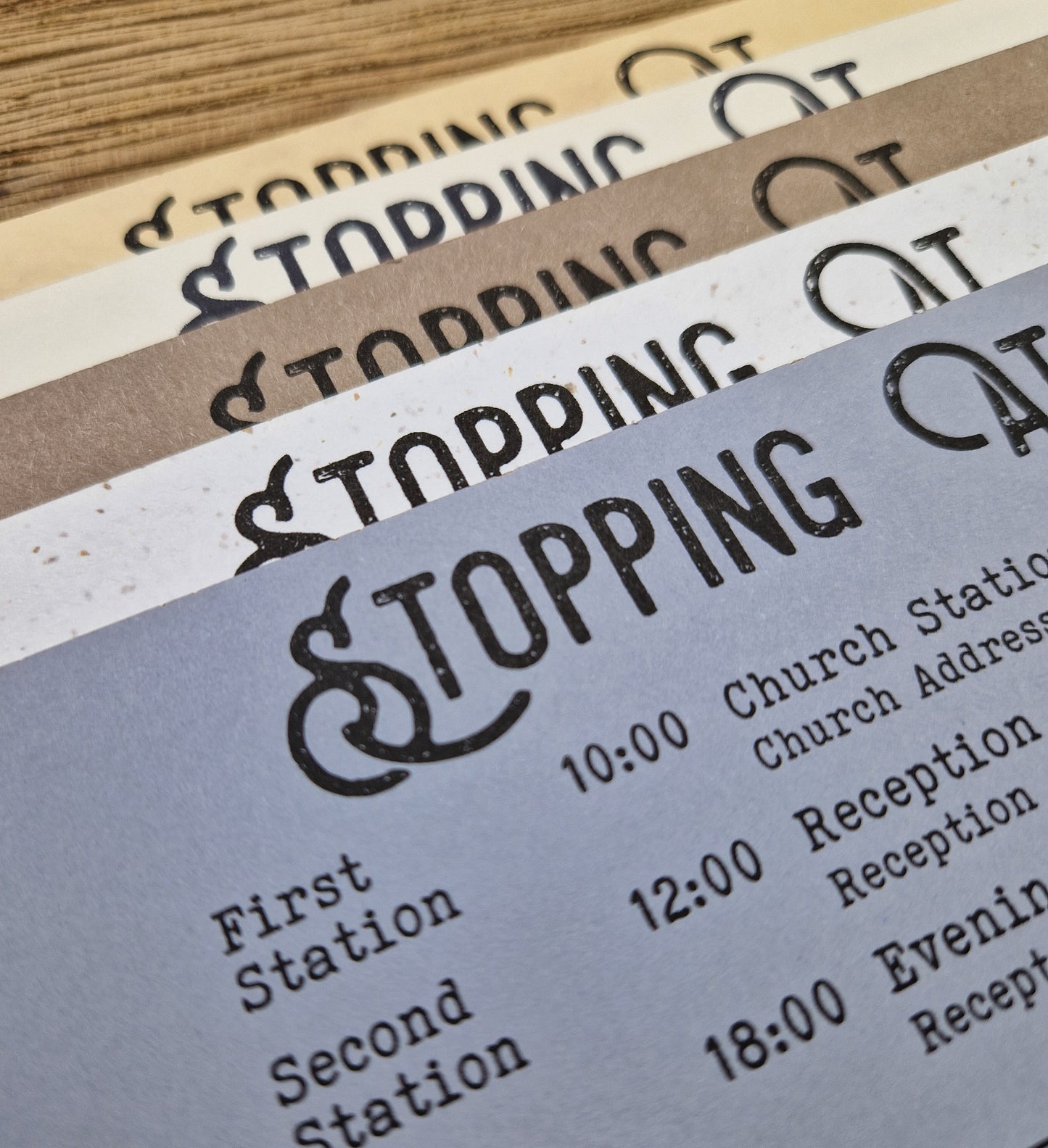 Vintage train ticket wedding invites displayed on a wooden background