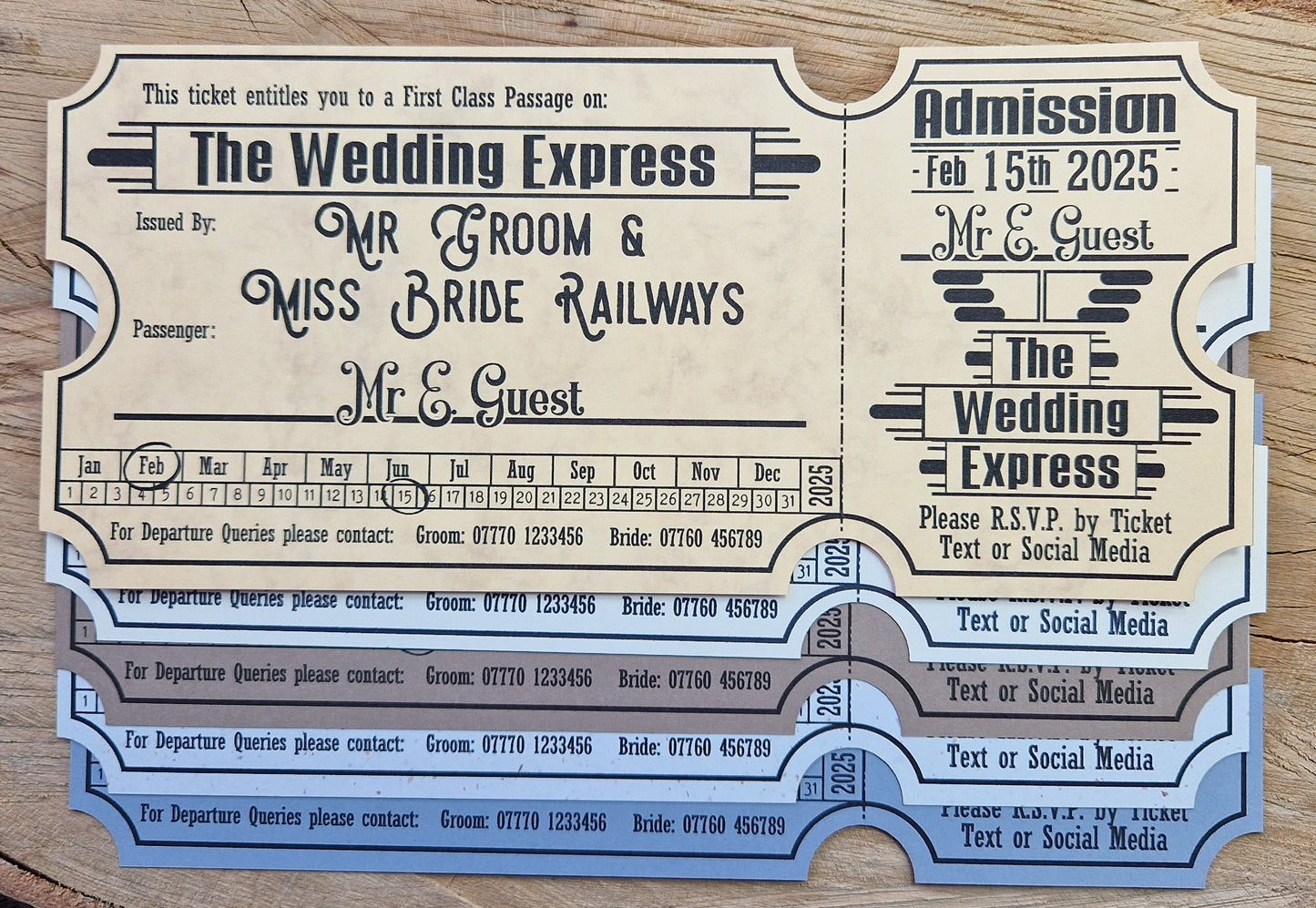Vintage train ticket wedding invites displayed on a wooden background