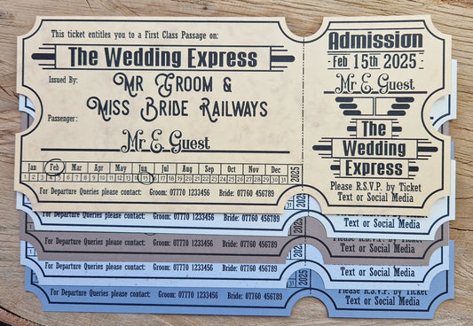 Vintage train ticket wedding invites displayed on a wooden background