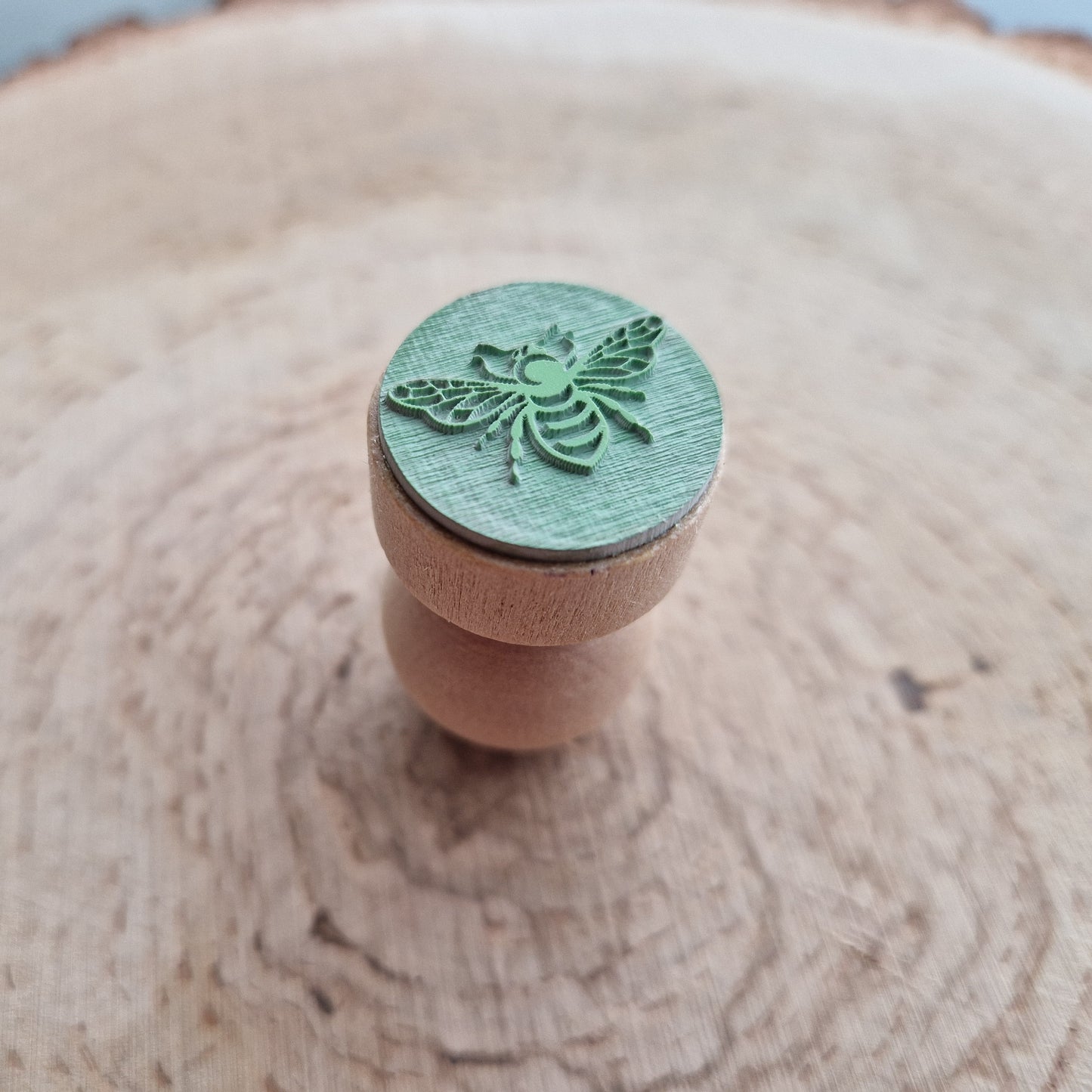 Eco Rubber bee stamp displayed on wooden background