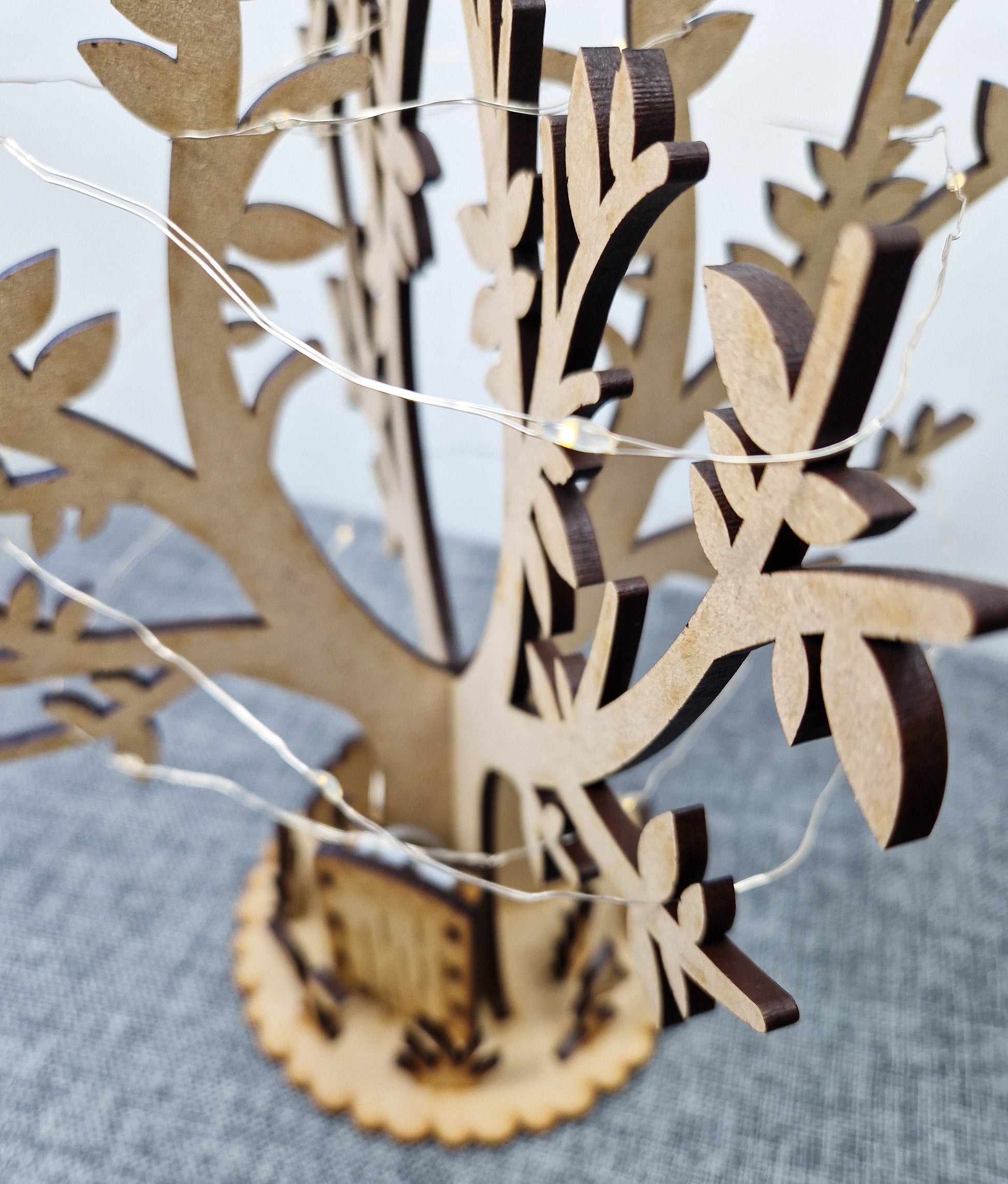 wooden tree and base displayed on grey background 
