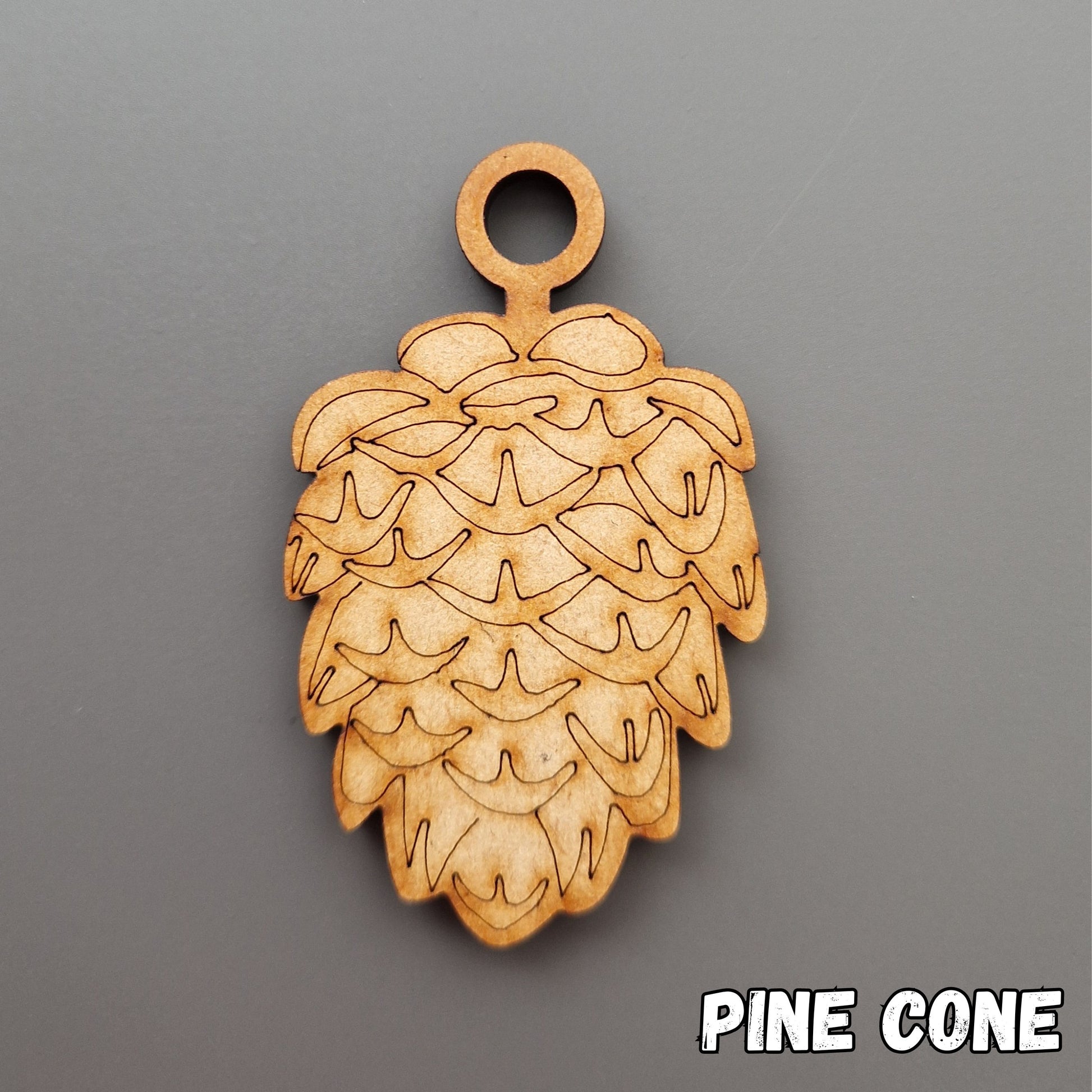 wooden pine cone shape displayed on grey background