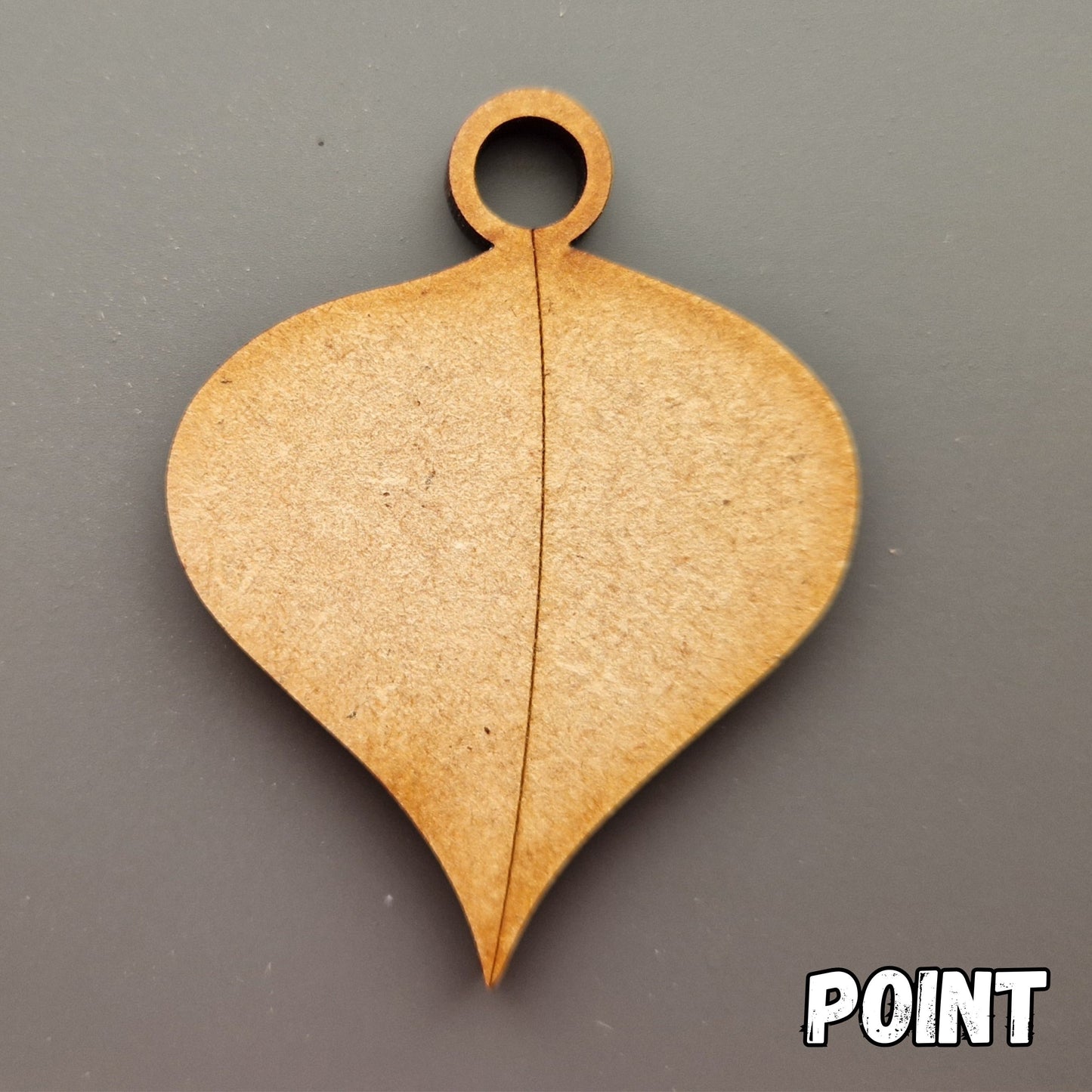 Wooden leaf shape displayed on grey background