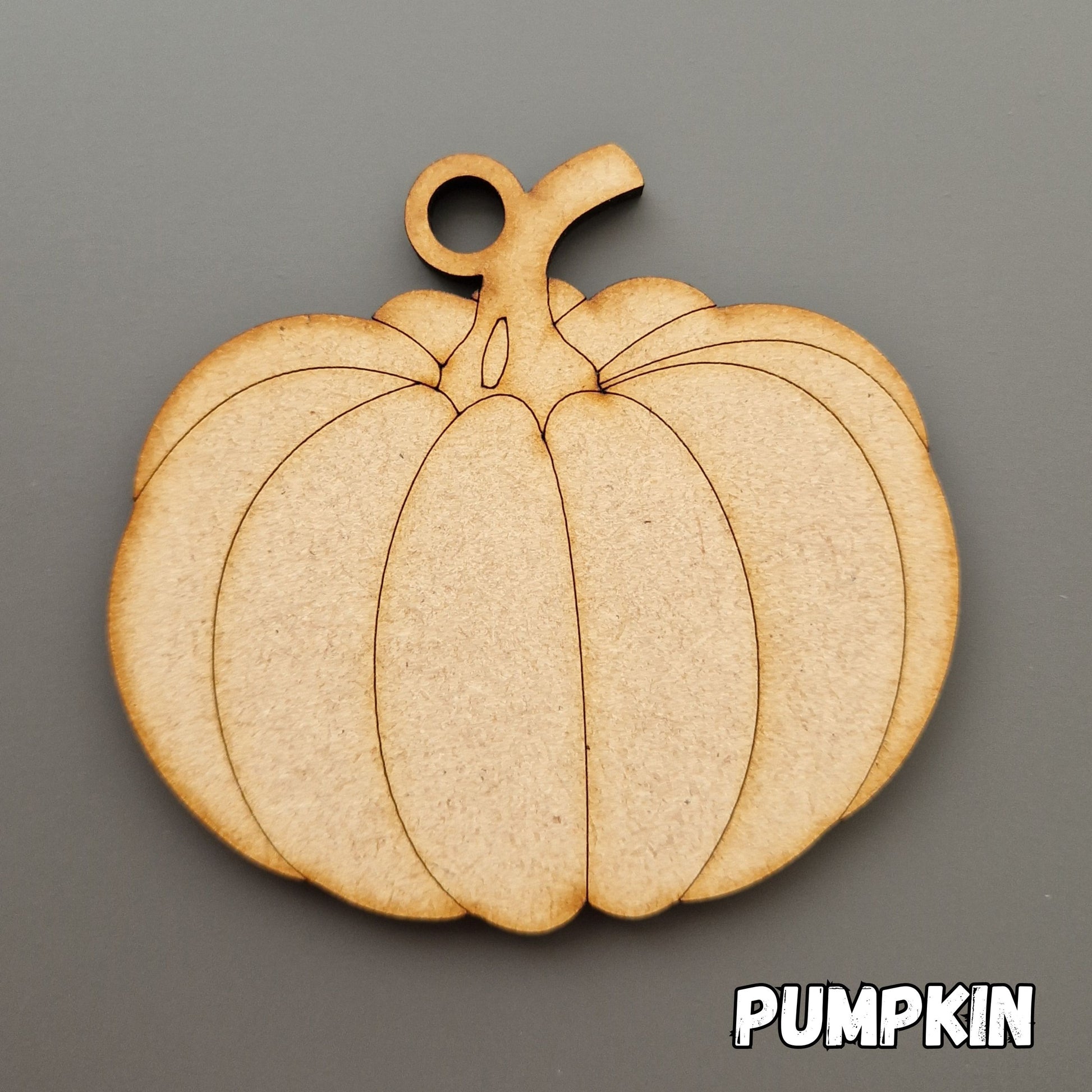 wooden pumpkin shape displayed on grey background