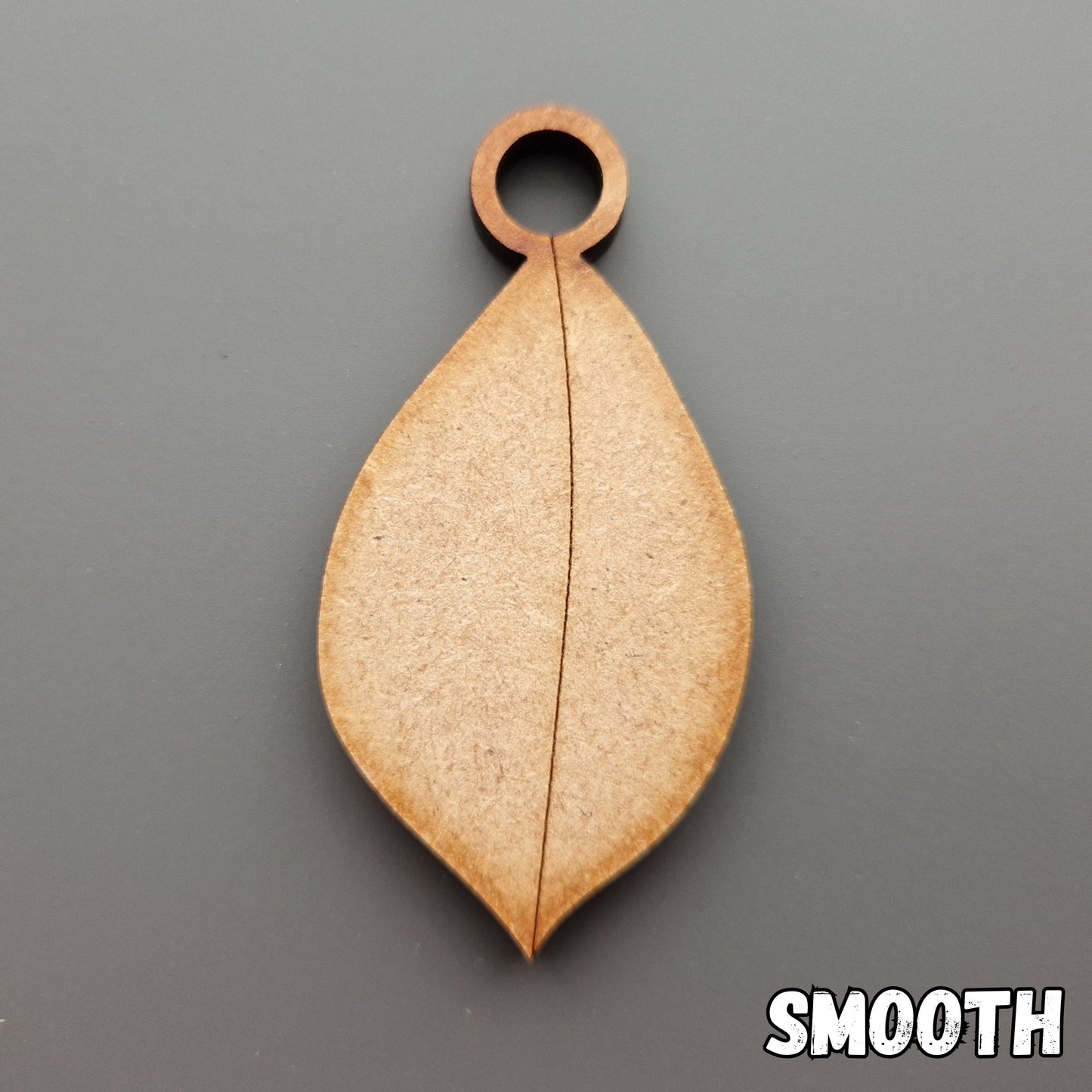 Wooden leaf shape displayed on grey background