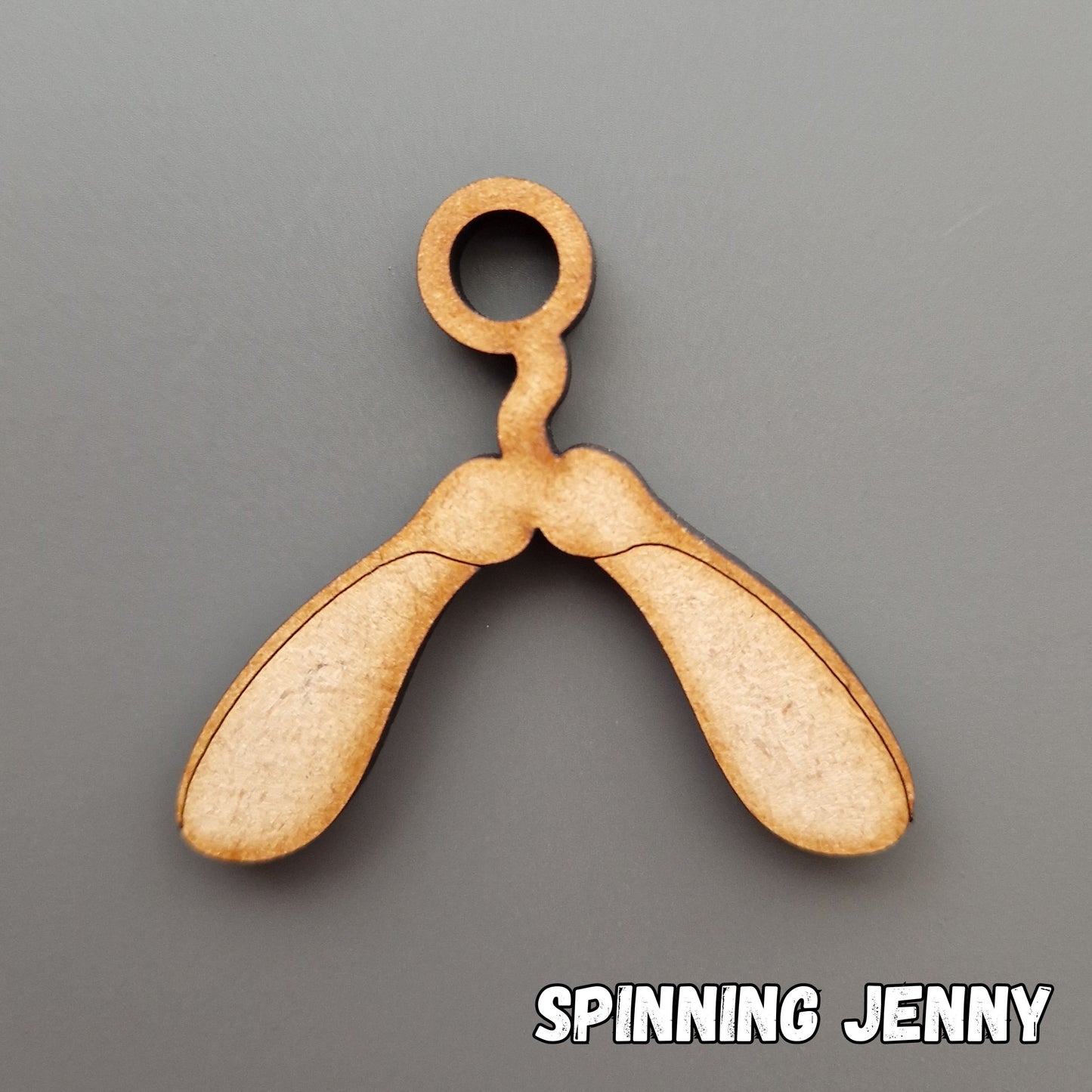wooden spinning jenny shape displayed on grey background