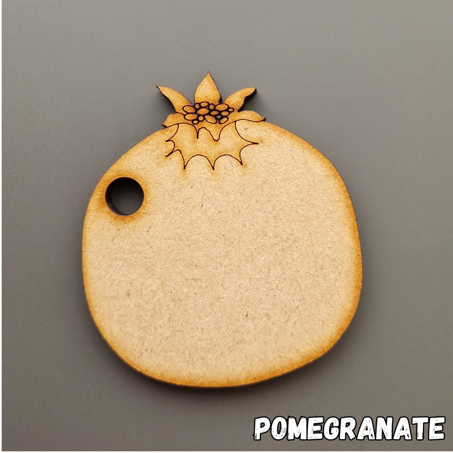 wooden pomegranate shape displayed on grey background